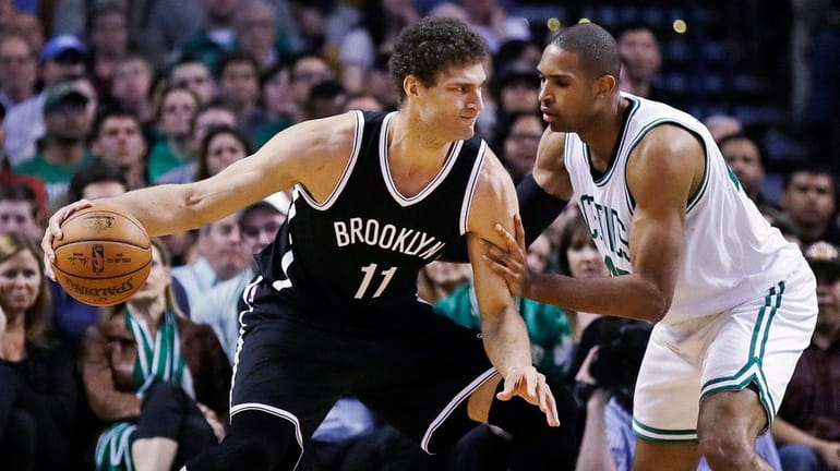 Brooklyn Nets center Brook Lopez (11) tries to get past...