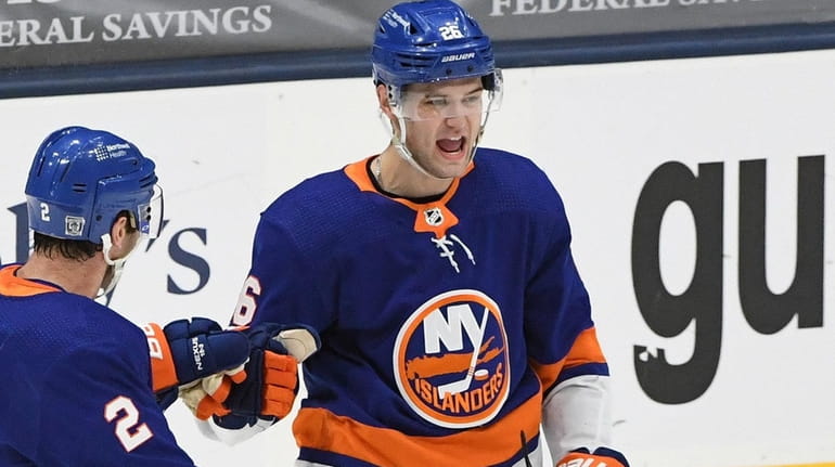 Islanders right wing Oliver Wahlstrom reacts with defenseman Nick Leddy...