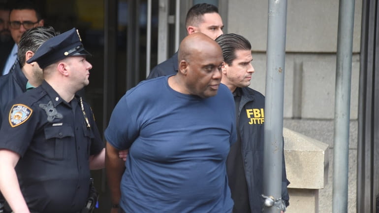 Alleged subway shooter Frank James is led out of the...