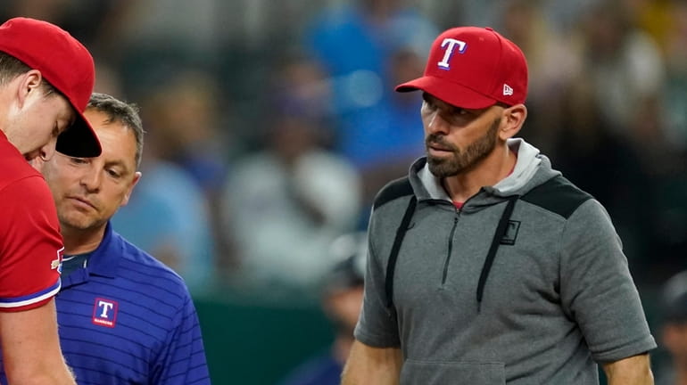 Texas Rangers starting pitcher Josh Sborz (66) is checked on...