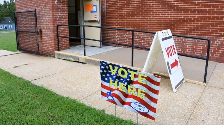 Signs direct voters toward the polling place at Division Avenue...