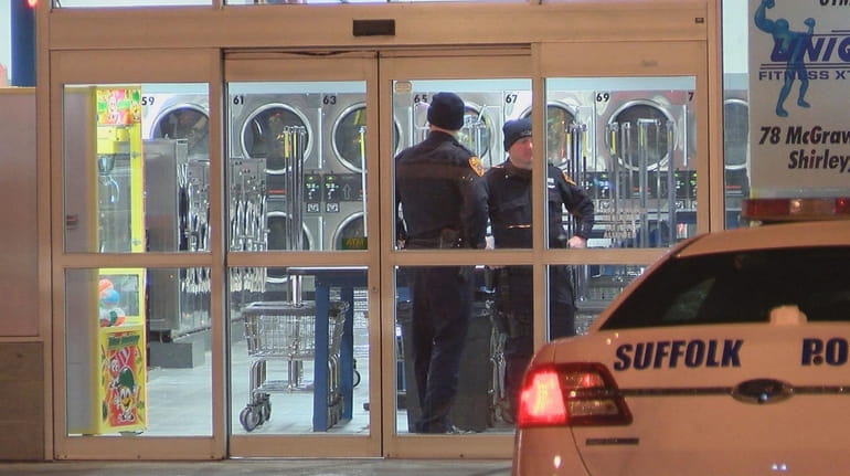 Suffolk County police investigate at the Laundry Kingdom on Montauk Highway...
