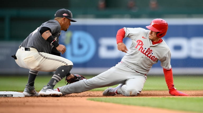 Philadelphia Phillies' J.T. Realmuto, right, is caught trying to steal...
