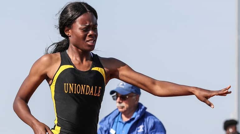 Zaria Fuller of Uniondale reaches for the finish line in...
