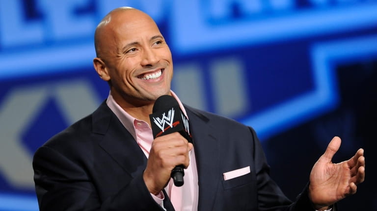 Actor and former WWE Superstar Dwayne "The Rock" Johnson participates...