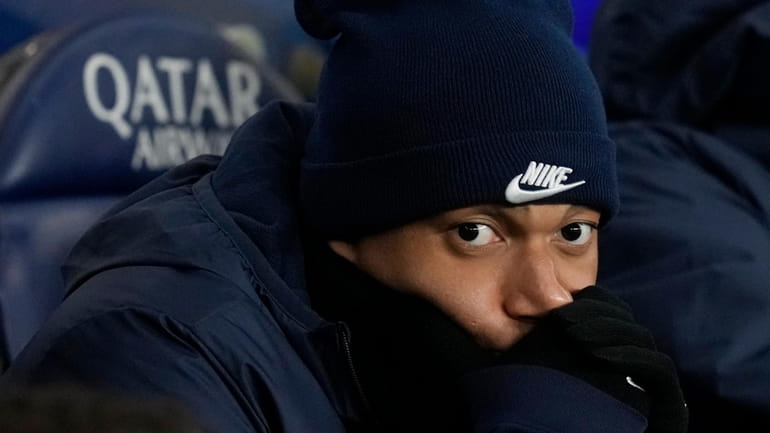 PSG's Kylian Mbappe sits on the bench during the French...