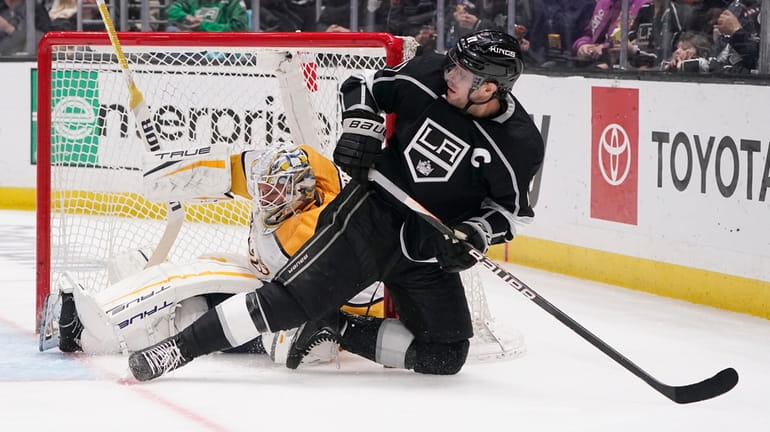 Los Angeles Kings center Anze Kopitar, right, collides with Nashville...