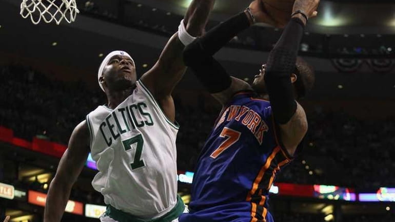 Jermaine O'Neal #7 of the Boston Celtics tries to block...