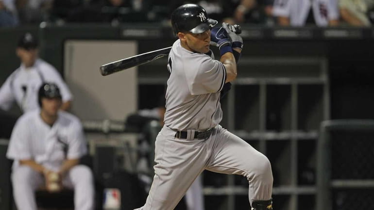 Derek Jeter #2 of the New York Yankees hits a...