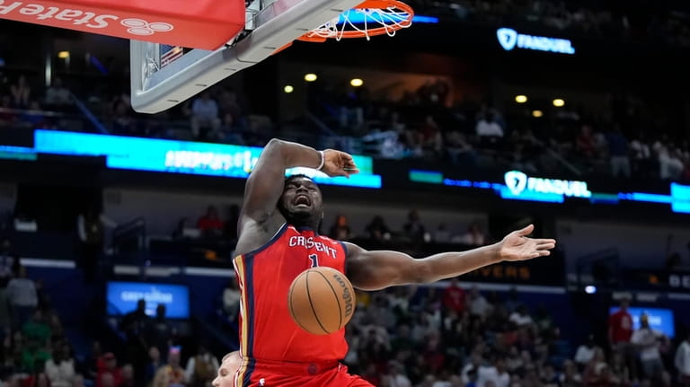 New Orleans Pelicans forward Zion Williamson slam dunks on a...