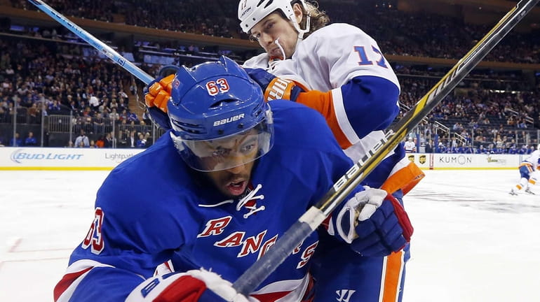 Anthony Duclair of the Rangers is checked in the second...