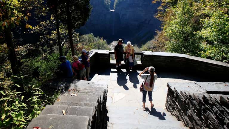 Visitors pose for a photograph at Taughannock Falls State Park,...