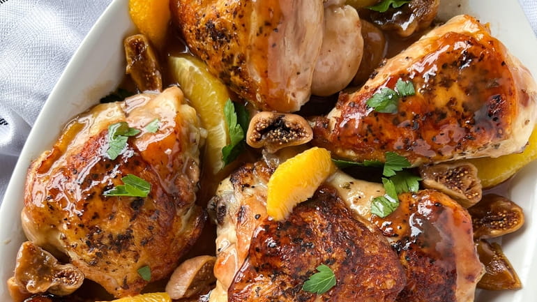 Roast chicken served with figs plumped in port, oranges, and...