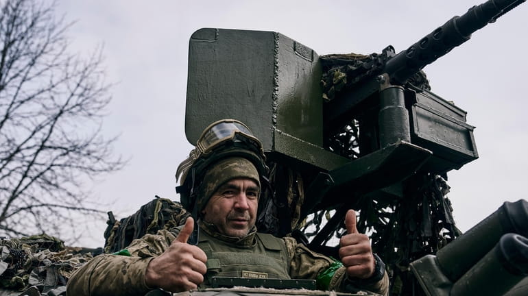A Ukrainian soldier gives thumbs up near Bakhmut, the site...