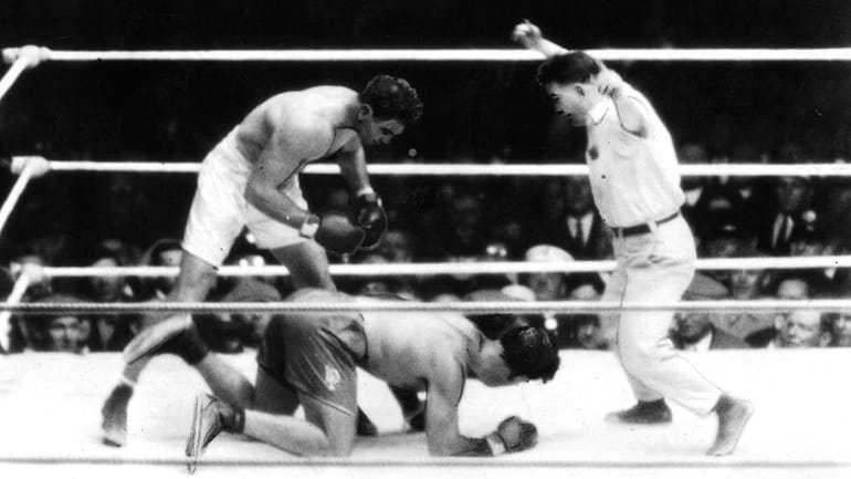 Jack Dempsey, left, knocks down Luis Angel Firpo during their...