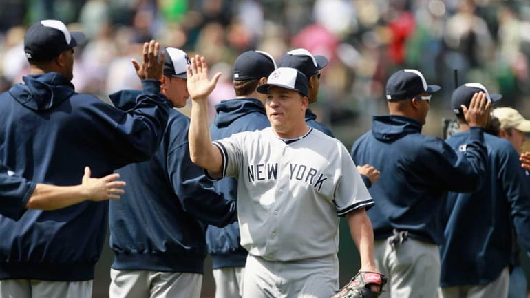 Bartolo Colon is congratulated by teammates after he pitched a...