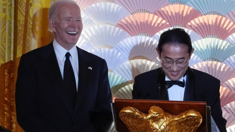 President Joe Biden listens as Japanese Prime Minister Fumio Kishida...