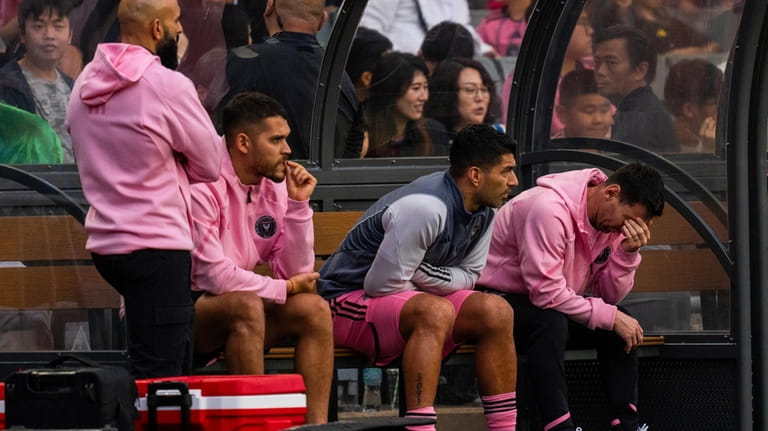 Inter Miami's Lionel Messi, right, reacts from the bench during...