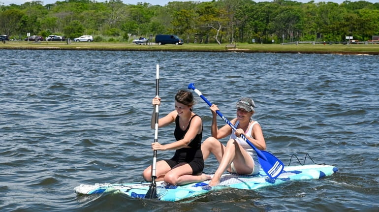 Michelle Maratea, right, and her daughter Meghann Fitzmaurice paddle in the...