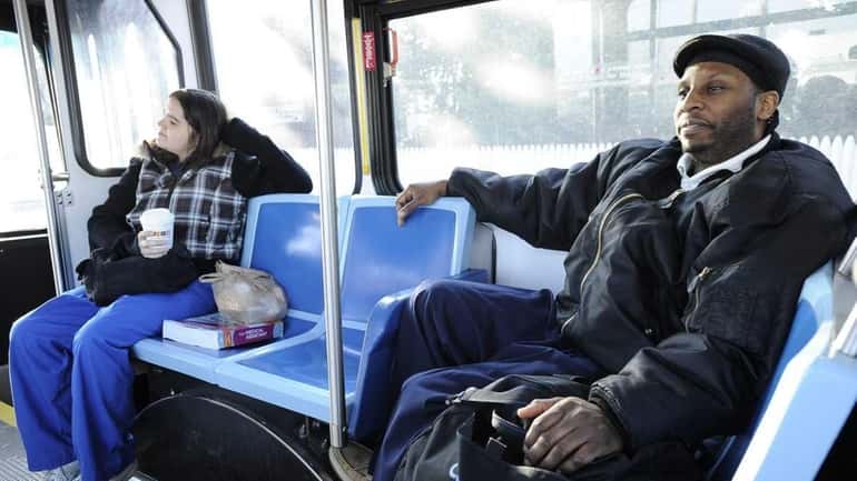 Gregory Spandy of Westbury rides the bus early Wednesday morning...