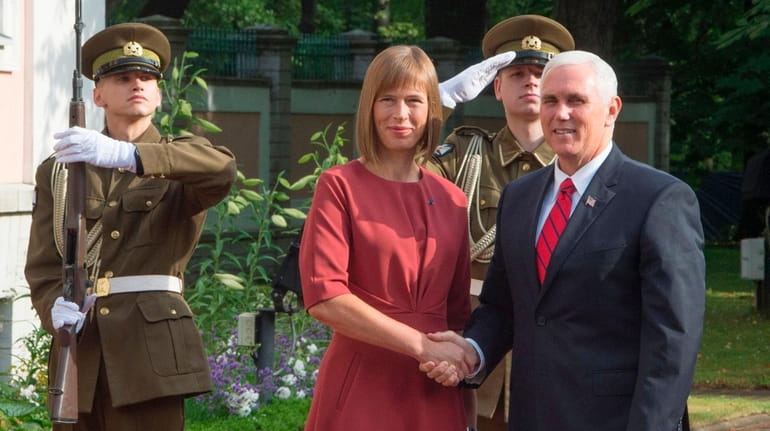 Estonian President Kersti Kaljulaid greets Vice President Mike Pence in...
