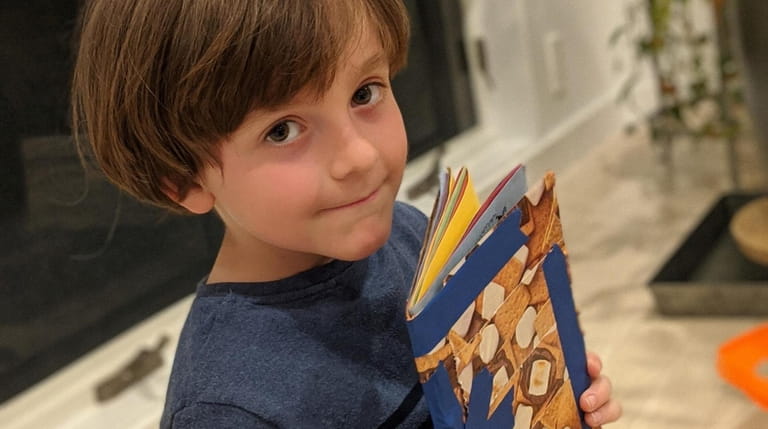 Lo'am Lapidus, 7, of Setauket made a sketchbook while watching...