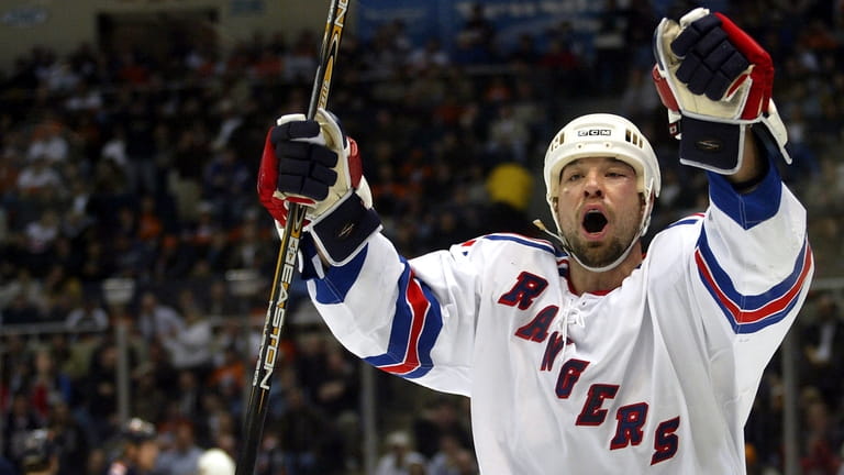 The Rangers' Chris Simon celebrates his second-period goal against the Islanders...