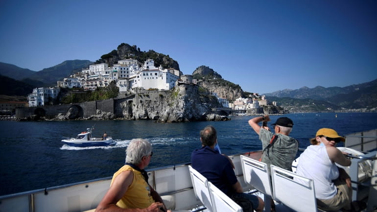 Tourist sail off Amalfi on the Amalfi coast in southern...