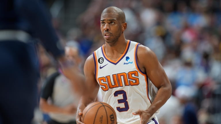 Phoenix Suns guard Chris Paul looks to pass the ball...