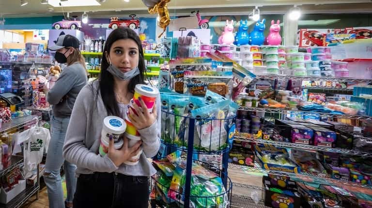 Funky Monkey Toys and Books Store employee Isabella Barba, 17,  stacks...