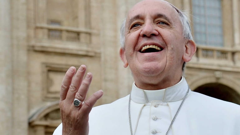 Pope Francis smiles to pilgrims in Saint Peter's square at...