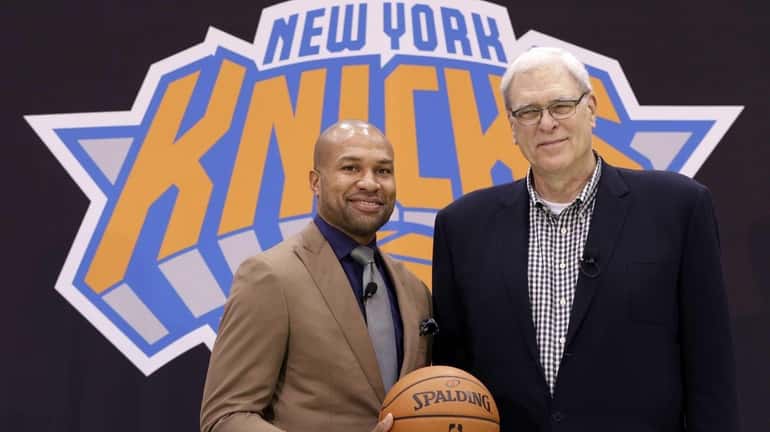 Knicks president Phil Jackson, right, poses with Derek Fisher during...