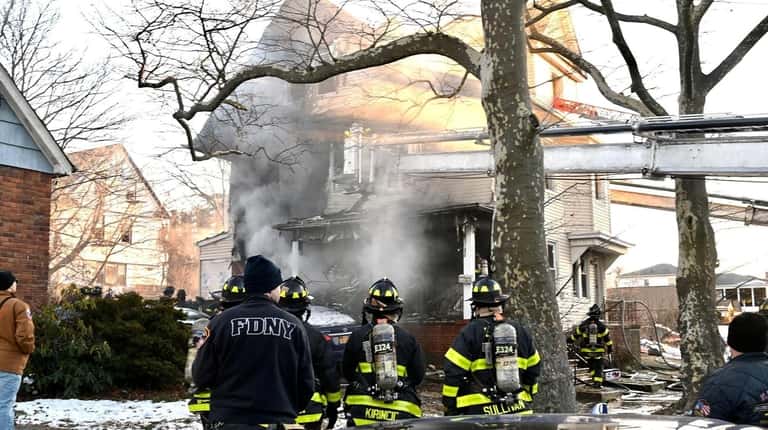 Firefighters respond to the house fire in Far Rockaway on...