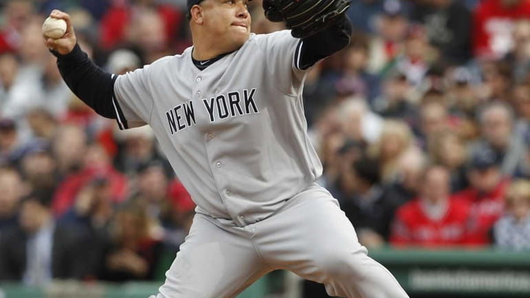 The Yankees' Bartolo Colon delivers against the Red Sox during...