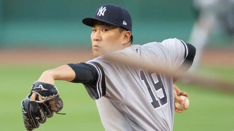 Yankees starting pitcher Masahiro Tanaka pitches against the Boston Red...