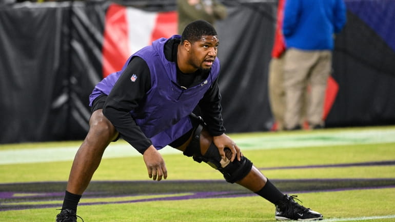 Baltimore Ravens defensive tackle Calais Campbell stretches during pre-game warm-ups...