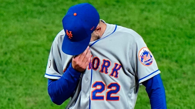 Mets pitcher Rick Porcello wipes his face during the fourth...
