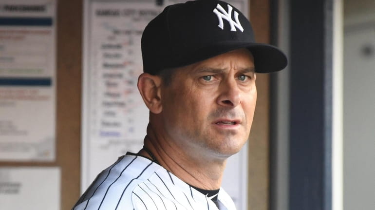 Yankees manager Aaron Boone looks on from the dugout against...