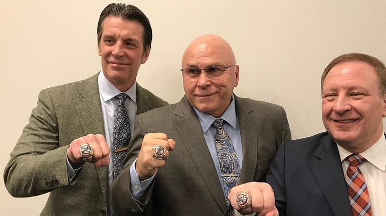 From left, Lane Lambert, Barry Trotz and Mitch Korn display their...