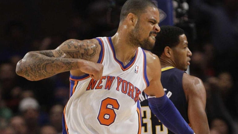 Knicks' Tyson Chandler reacts as Indiana Pacers' Danny Granger walks...
