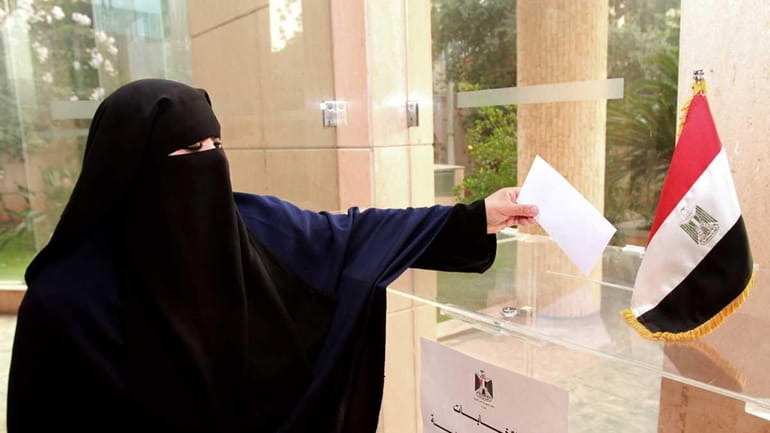An Egyptian expatriate living in Lebanon casts her ballot at...