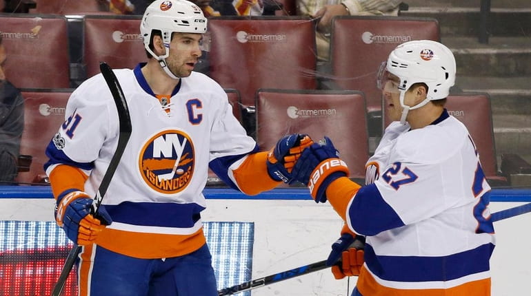 John Tavares, left, is congratulated by Anders Lee after he...