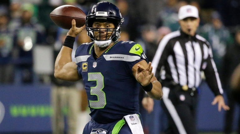 Seahawks quarterback Russell Wilson drops back to pass against the...