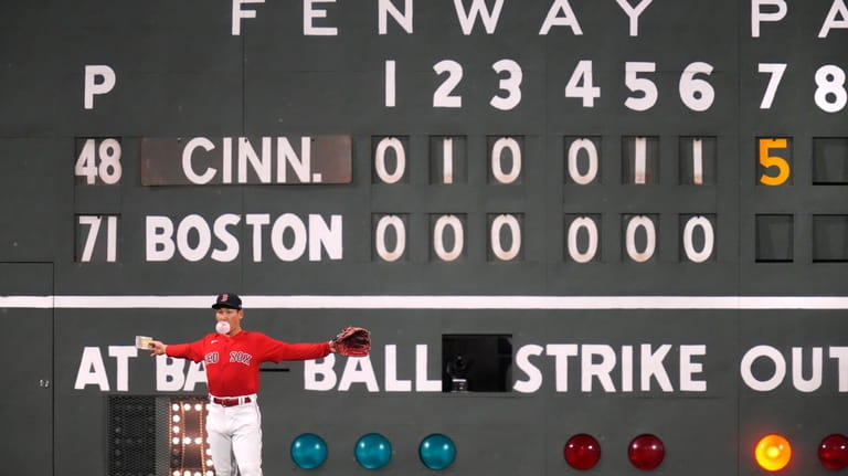 Boston Red Sox left fielder Masataka Yoshida blows a bubble...