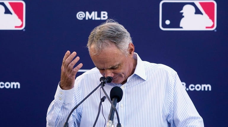 Major League Baseball Commissioner Rob Manfred gestures as he answers...