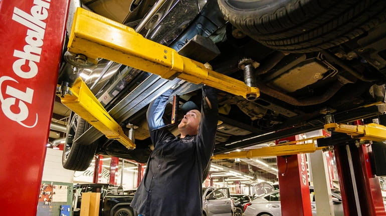 Technician Louie Cafaro at work in the service department at...