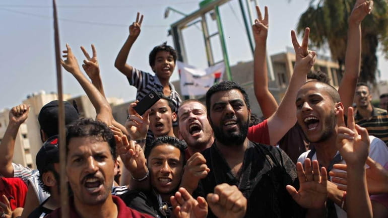 Libyans celebrate the liberation of their district of Qasr Bin...