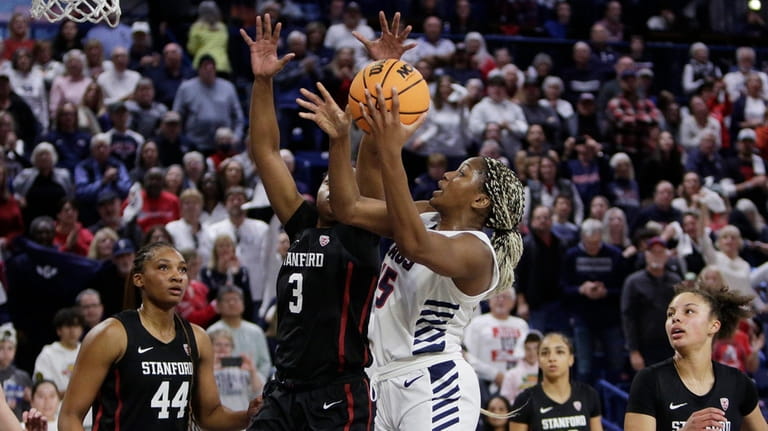 Gonzaga forward Yvonne Ejim, center right, shoots while pressured by...