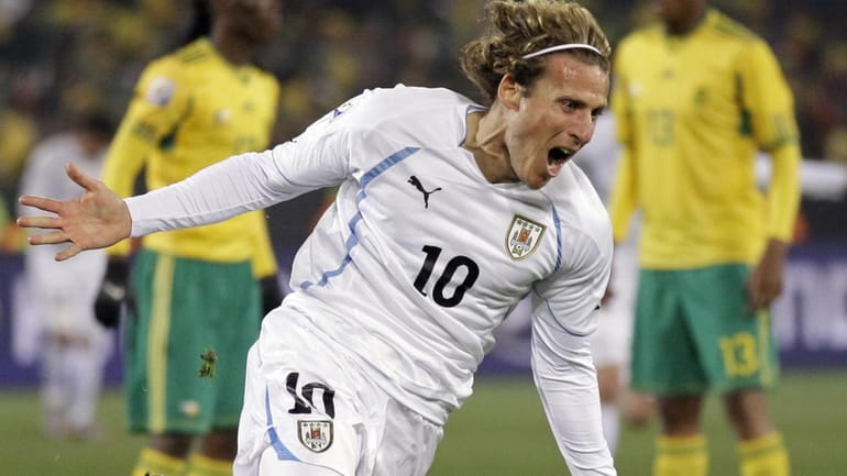Uruguay's Diego Forlan celebrates after scoring against South Africa during...