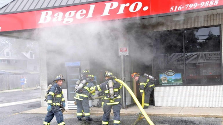 Massapequa fire fighters battle a smokey blaze at the Bagel...